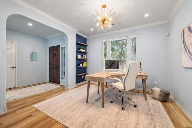 office area featuring crown molding, wood finished floors, arched walkways, and baseboards