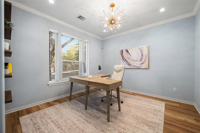 office featuring visible vents, wood finished floors, crown molding, baseboards, and a chandelier