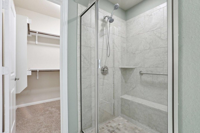 full bath featuring a spacious closet and a stall shower