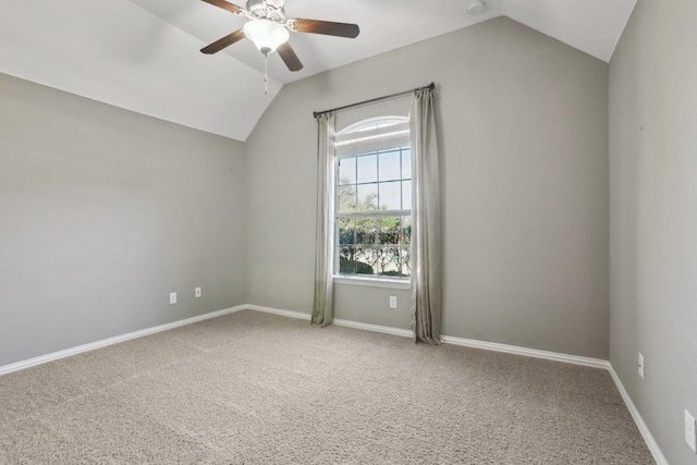 empty room with baseboards, a ceiling fan, and vaulted ceiling