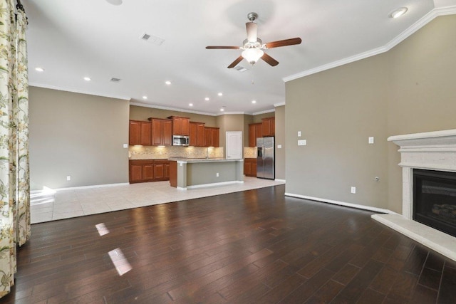 unfurnished living room featuring visible vents, a fireplace with raised hearth, baseboards, ceiling fan, and light wood-type flooring