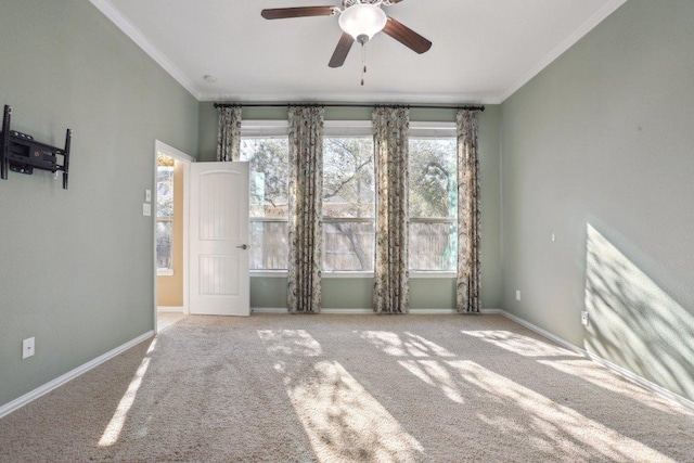 unfurnished room featuring plenty of natural light, ornamental molding, and a ceiling fan