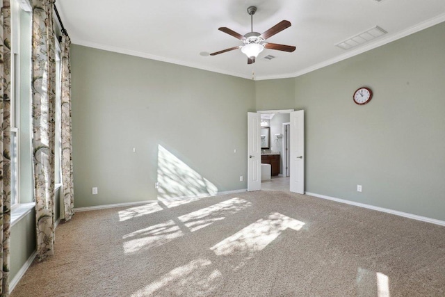 unfurnished bedroom with visible vents, baseboards, and ornamental molding