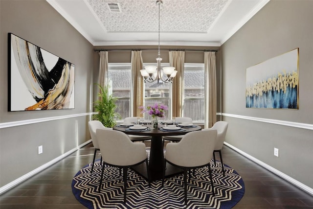 dining area with a chandelier, visible vents, a healthy amount of sunlight, and wood finished floors