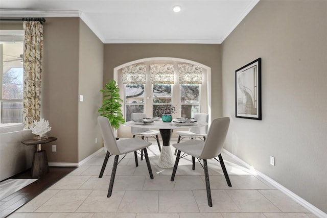 dining space with light tile patterned floors, baseboards, and ornamental molding