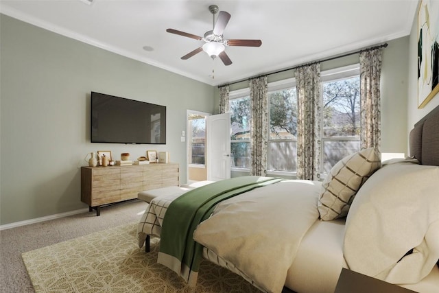 carpeted bedroom with baseboards, a ceiling fan, and crown molding