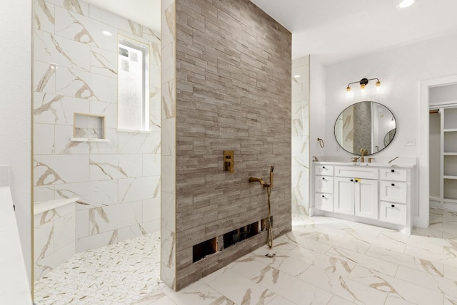 full bathroom with vanity, a walk in closet, a walk in shower, and marble finish floor