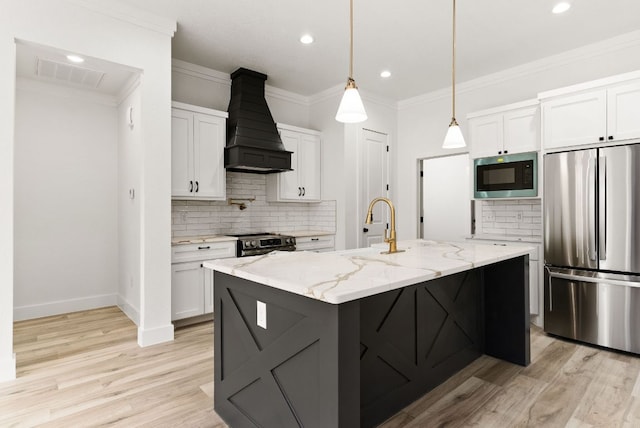 kitchen with visible vents, ornamental molding, stainless steel appliances, custom exhaust hood, and white cabinetry