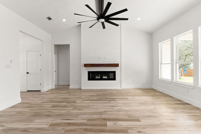 unfurnished living room with baseboards, visible vents, light wood-style flooring, ceiling fan, and a large fireplace