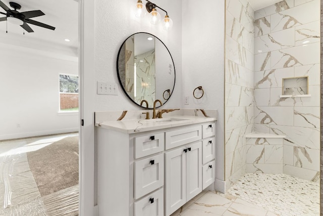 full bath with marble finish floor, a sink, double vanity, tiled shower, and ceiling fan