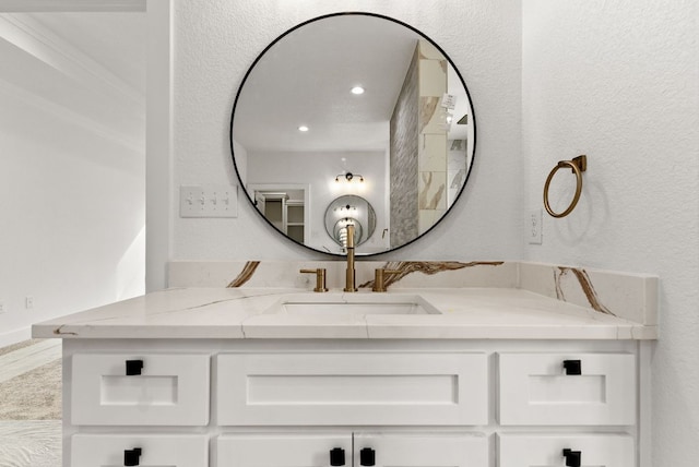 bathroom with vanity and a textured wall