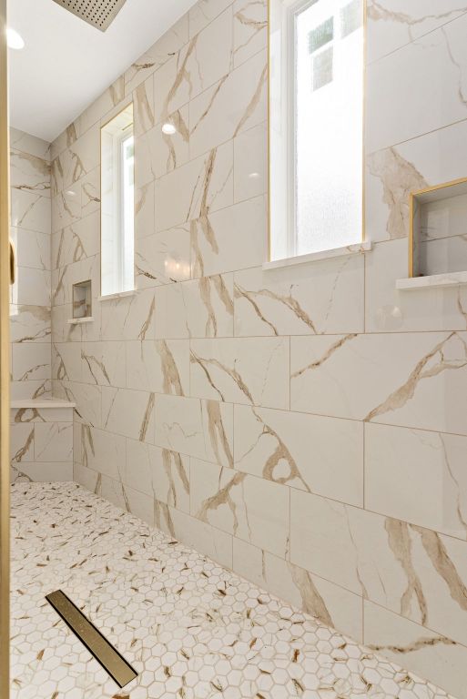 bathroom with a tile shower