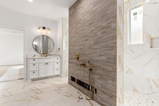 bathroom featuring recessed lighting, marble finish floor, a walk in shower, and vanity