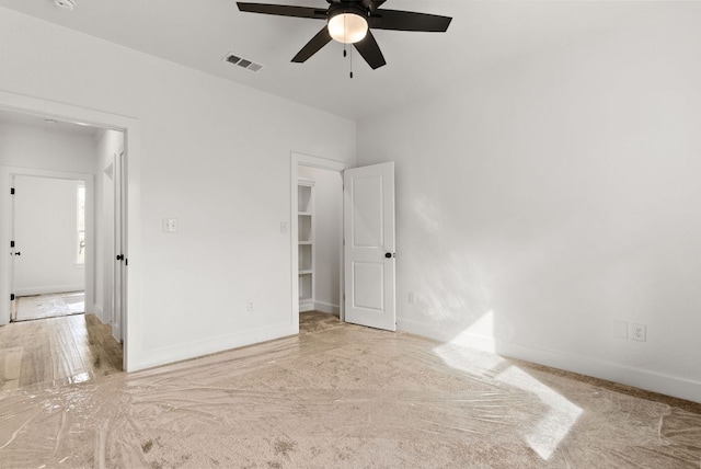 unfurnished bedroom with a ceiling fan, baseboards, and visible vents