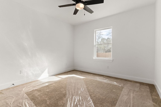 empty room with baseboards and ceiling fan