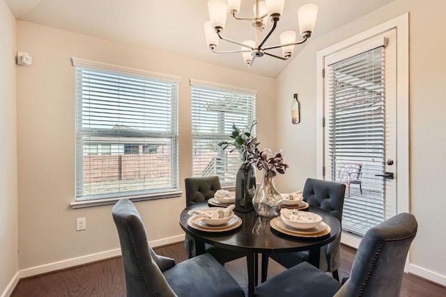 dining space featuring baseboards, dark wood-type flooring, and a chandelier