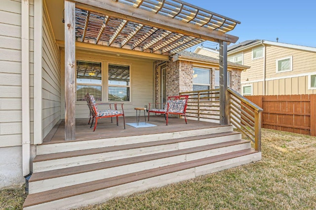 wooden terrace with a porch, fence, and a pergola