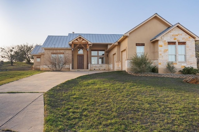 view of front of property featuring metal roof, stone siding, a front yard, and a standing seam roof