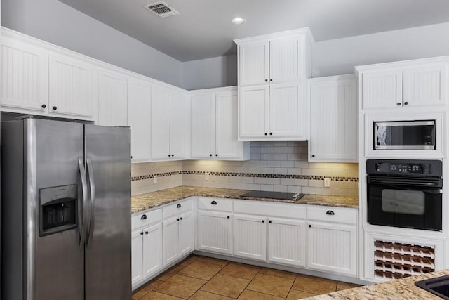 kitchen with white cabinetry, black appliances, tasteful backsplash, and visible vents