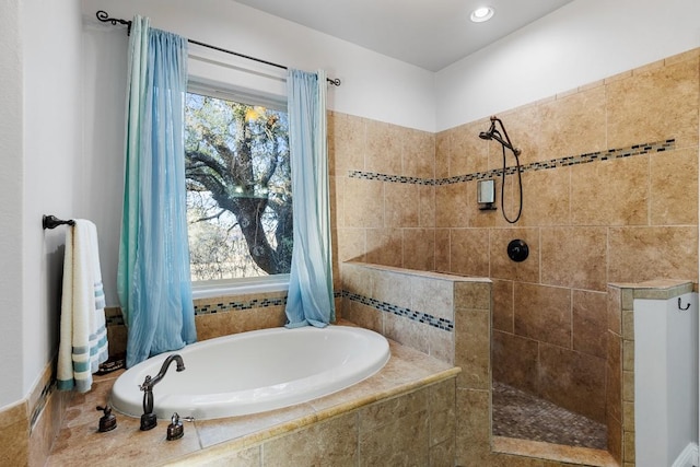 full bathroom featuring a bath and a walk in shower