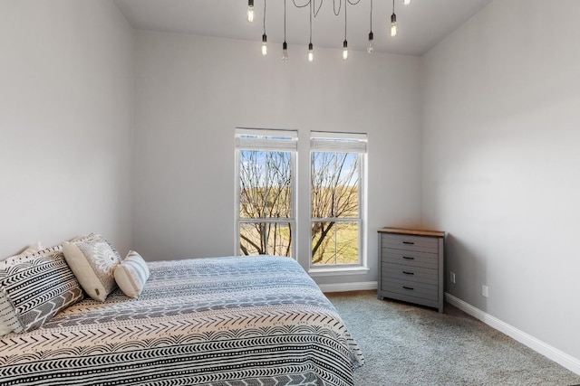 carpeted bedroom featuring baseboards