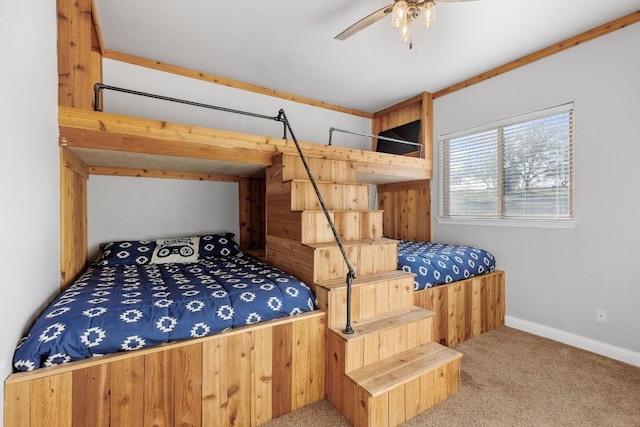 carpeted bedroom with ceiling fan and baseboards