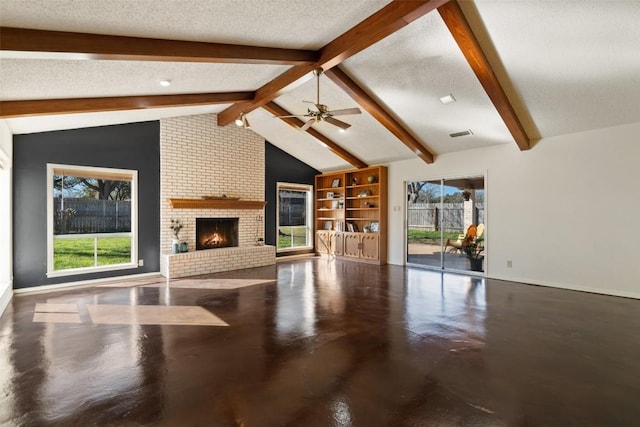 unfurnished living room with lofted ceiling with beams, a textured ceiling, finished concrete floors, and ceiling fan