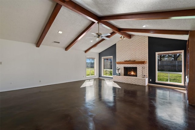 unfurnished living room with a brick fireplace, vaulted ceiling with beams, finished concrete flooring, ceiling fan, and a textured ceiling