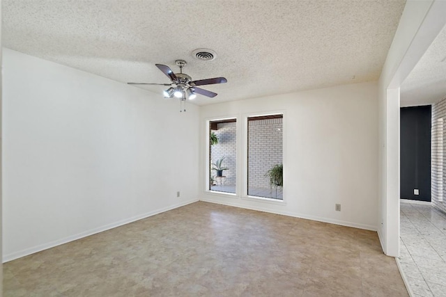 unfurnished room with baseboards, visible vents, a textured ceiling, and ceiling fan