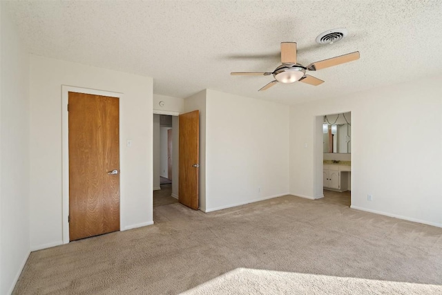 unfurnished bedroom with carpet flooring, visible vents, and a textured ceiling