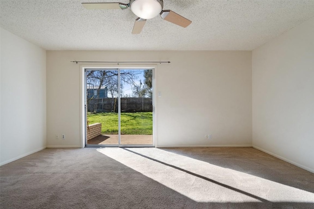 unfurnished room with a textured ceiling, carpet, baseboards, and ceiling fan