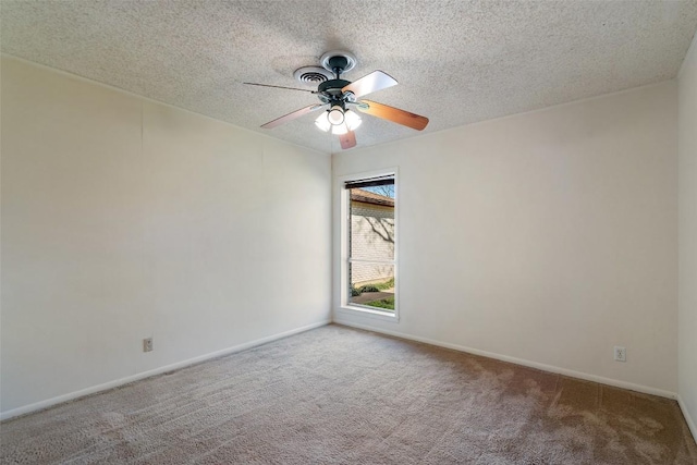 unfurnished room with carpet flooring, a textured ceiling, baseboards, and a ceiling fan