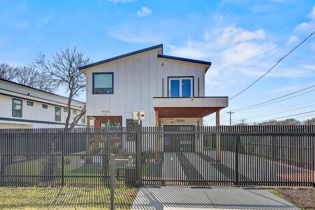 exterior space with a fenced front yard and a gate