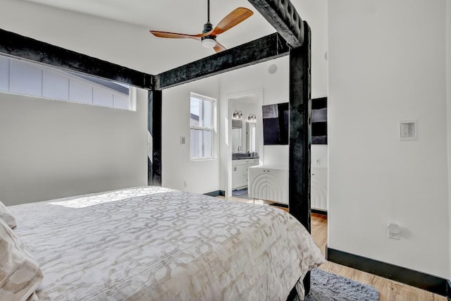 bedroom with a ceiling fan, light wood-style floors, and ensuite bathroom