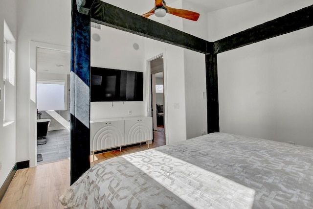 bedroom featuring multiple windows, ceiling fan, and wood finished floors