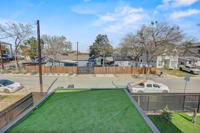 view of yard with a residential view and fence