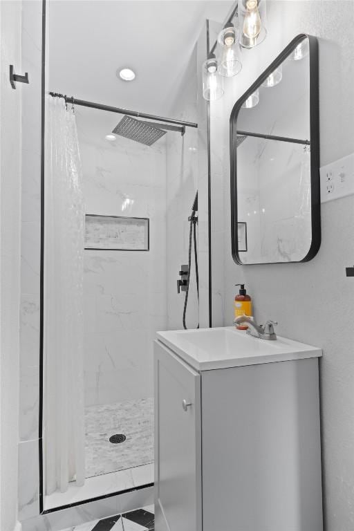 bathroom featuring a shower stall and vanity