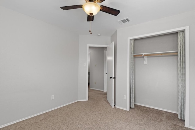 unfurnished bedroom with carpet, visible vents, a closet, and baseboards