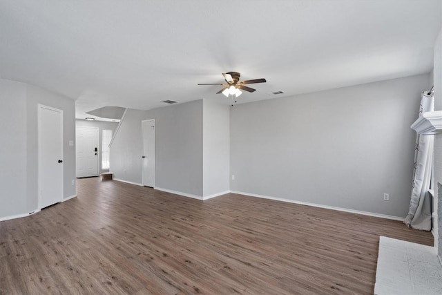 unfurnished living room with baseboards, wood finished floors, visible vents, and ceiling fan