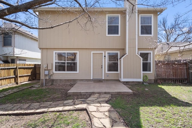 back of property with a patio area, a yard, and a fenced backyard