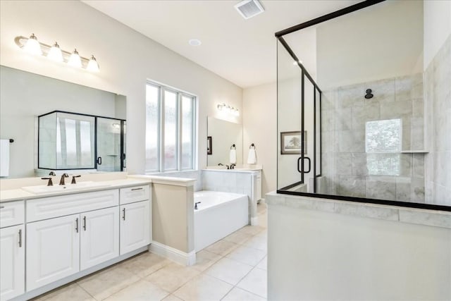 full bath with visible vents, a shower stall, tile patterned flooring, a bath, and vanity