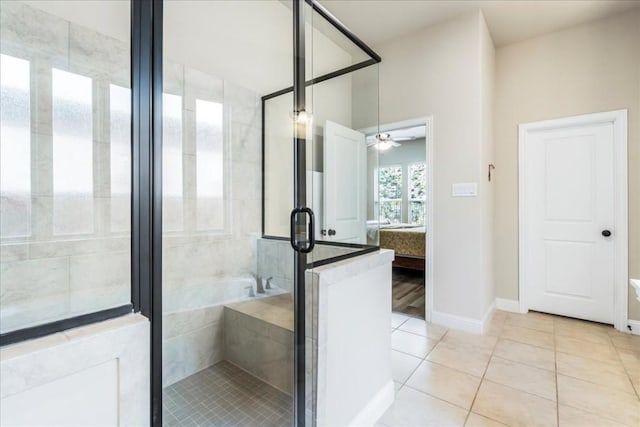 ensuite bathroom featuring ceiling fan, a shower stall, ensuite bathroom, tile patterned floors, and a washtub