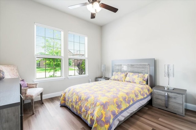 bedroom with wood finished floors, baseboards, and ceiling fan