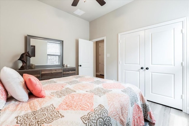 bedroom with a closet, ceiling fan, and wood finished floors