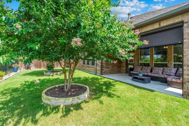 view of yard with a patio, fence, and an outdoor hangout area