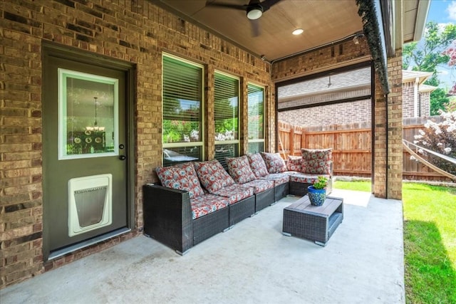 view of patio with an outdoor living space, heating unit, a ceiling fan, and fence