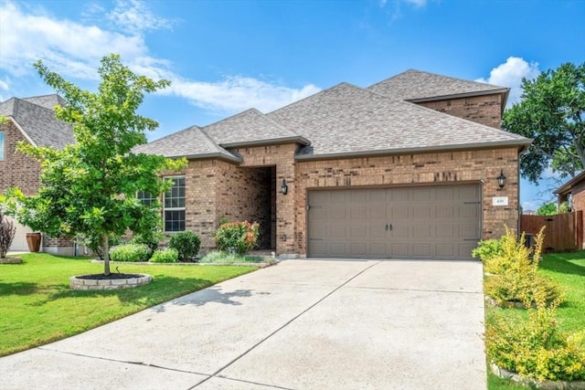 view of front of property with brick siding, a shingled roof, a front yard, a garage, and driveway