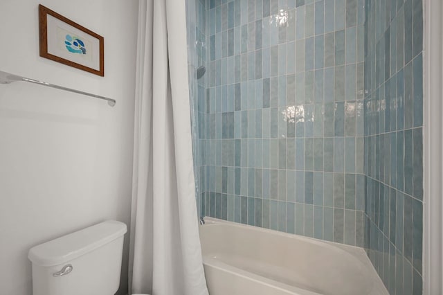 full bathroom with toilet and shower / bath combo with shower curtain