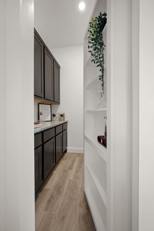 bar with baseboards and light wood-type flooring