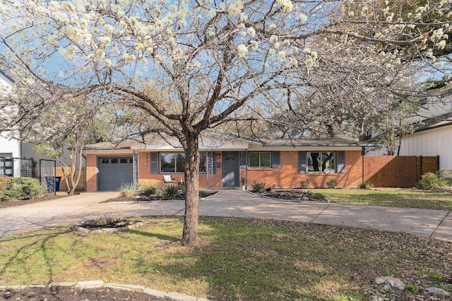 ranch-style home with brick siding, an attached garage, a front lawn, fence, and driveway